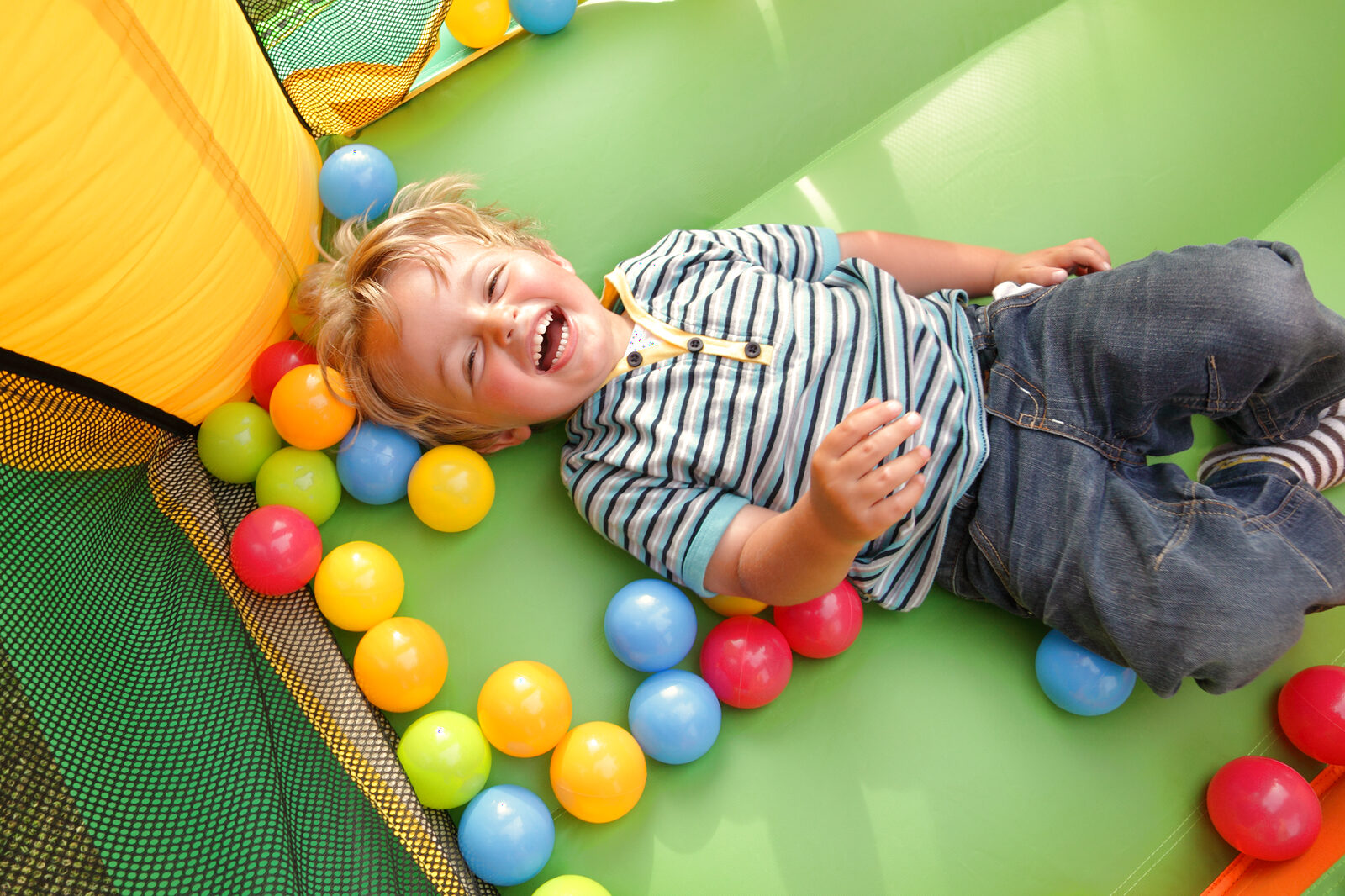 A child playing in a colourful indoor soft play area